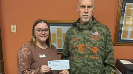 Community Foundation of Northeast Michigan Youth Advisory Council Members pose with a $505.00 check and posters advertising YAC Day